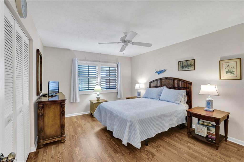 855 Ketch Drive, Unit 206 Naples, FL 34103 - Photo 9 of 17 Bedroom with a closet, wood finished floors, and ceiling fan