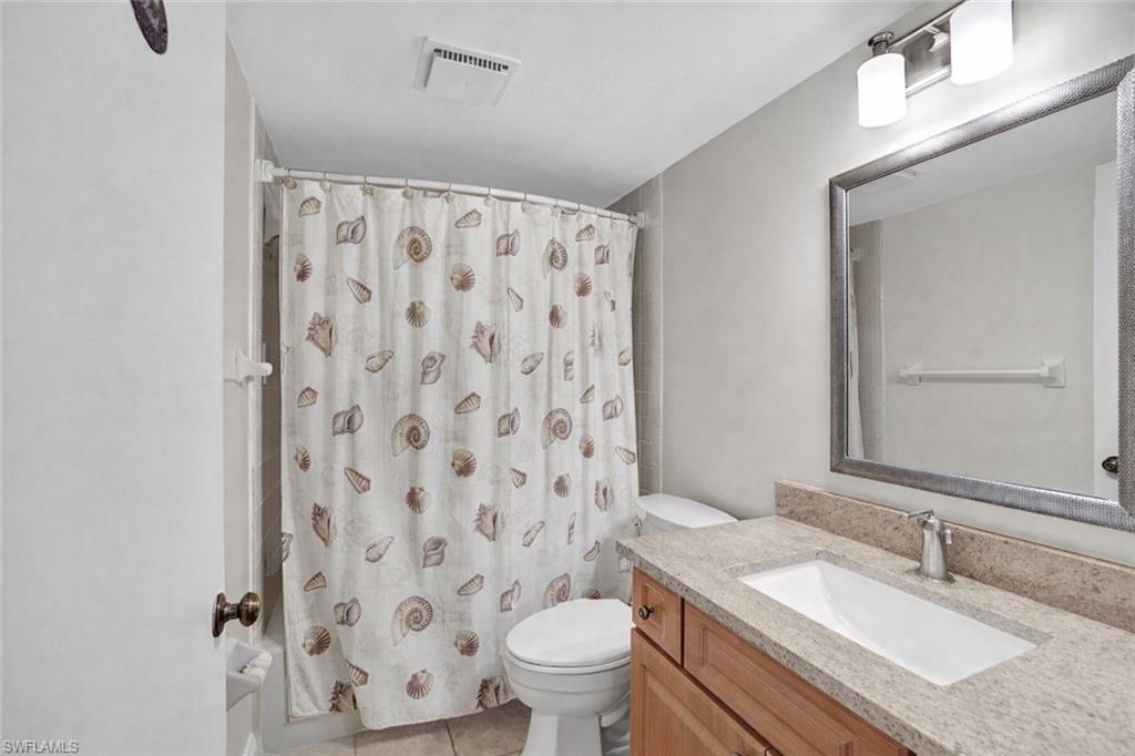 855 Ketch Drive, Unit 206 Naples, FL 34103 - Photo 10 of 17 Full bath featuring curtained shower and vanity