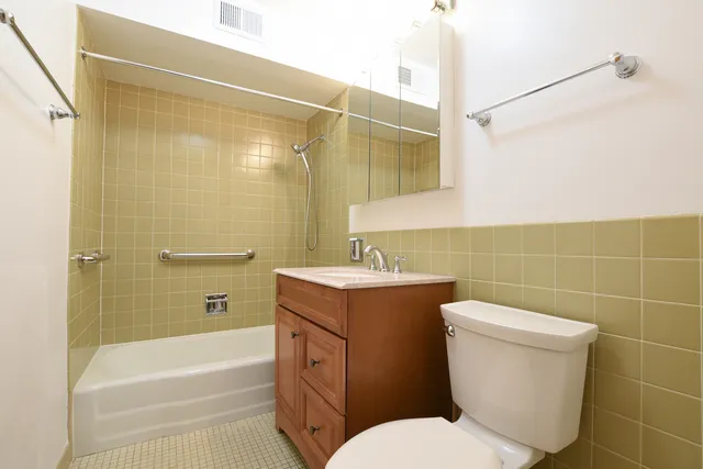 a bathroom with a toilet sink and shower