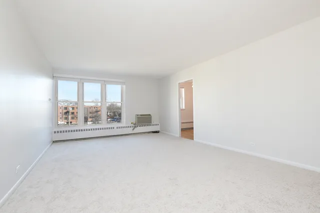 an empty room with large windows