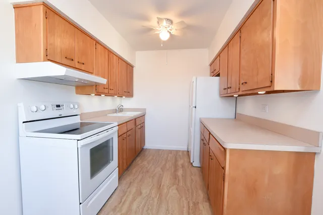 a kitchen with a sink a stove and cabinets