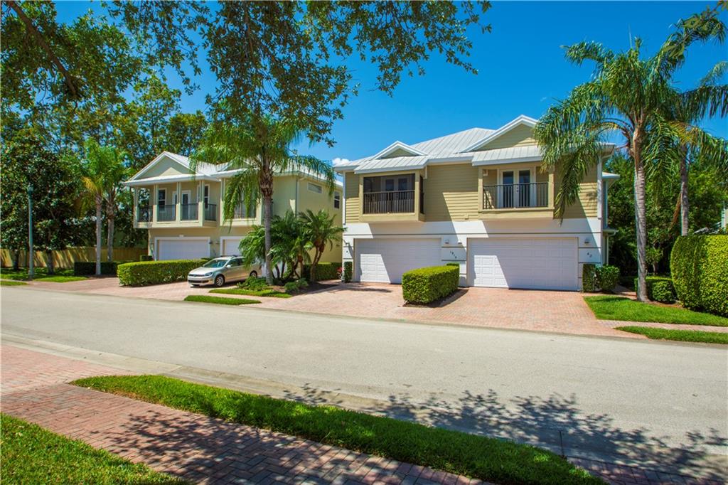1915 Bridgepointe Circle, Unit 41 Vero Beach, FL 32967 - Photo 1 of 36 a front view of a house with a yard and garage