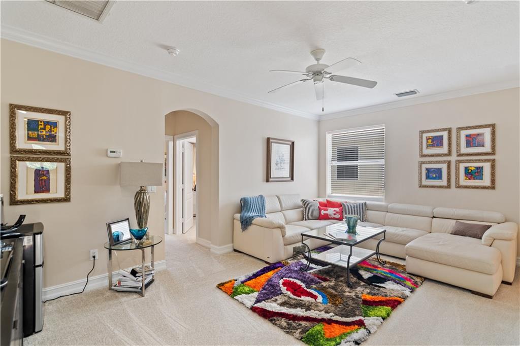 1915 Bridgepointe Circle, Unit 41 Vero Beach, FL 32967 - Photo 17 of 36 a living room with furniture and wooden floor