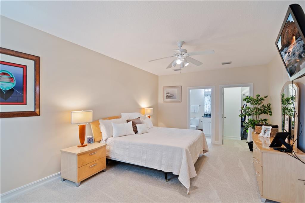1915 Bridgepointe Circle, Unit 41 Vero Beach, FL 32967 - Photo 19 of 36 a bedroom with a bed and a chandelier