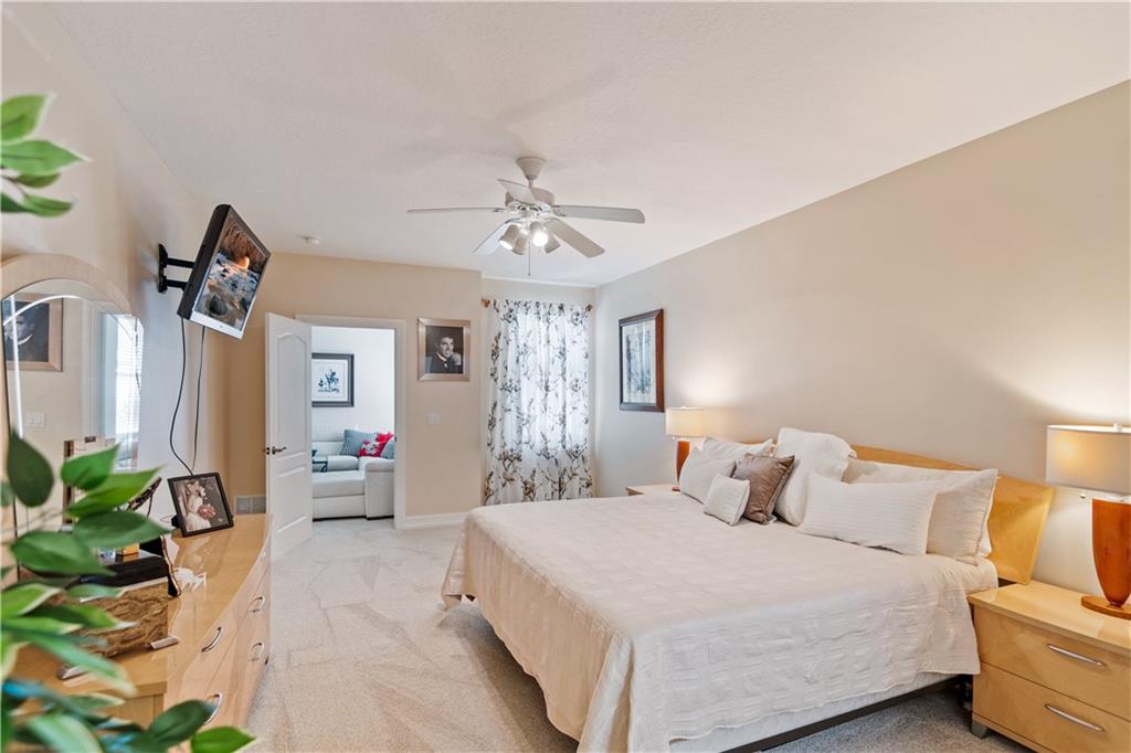 1915 Bridgepointe Circle, Unit 41 Vero Beach, FL 32967 - Photo 20 of 36 a bedroom with a bed and ceiling fan