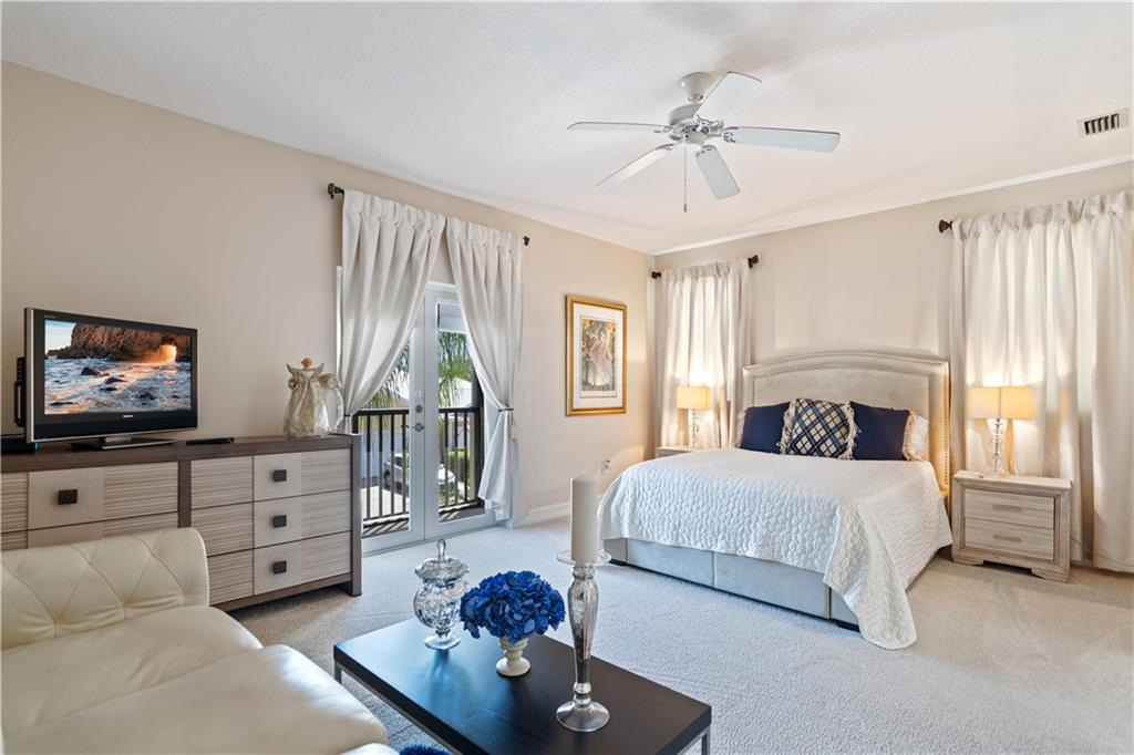 1915 Bridgepointe Circle, Unit 41 Vero Beach, FL 32967 - Photo 22 of 36 a bedroom with furniture and a flat screen tv