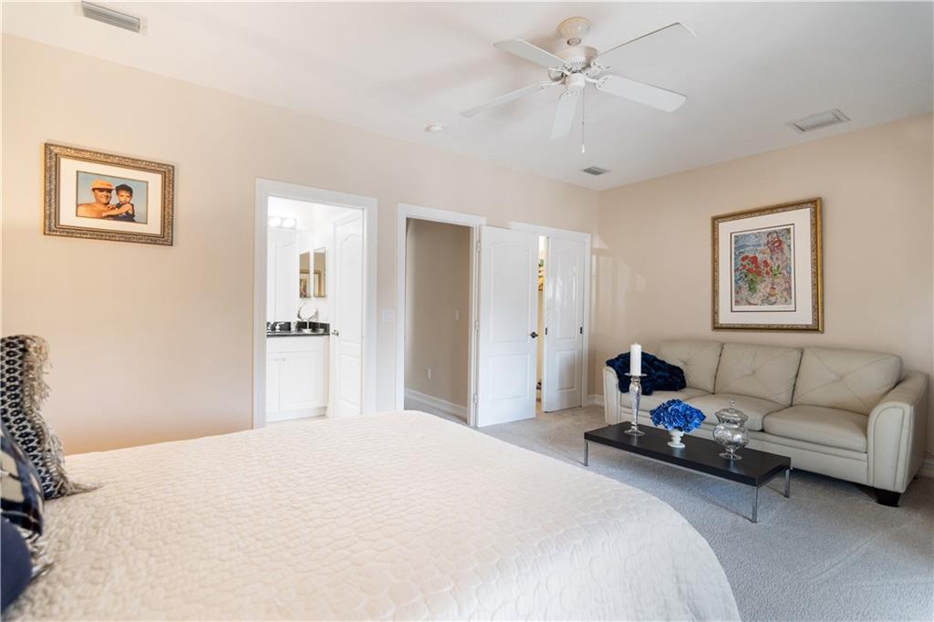 1915 Bridgepointe Circle, Unit 41 Vero Beach, FL 32967 - Photo 23 of 36 a bedroom with a bed couches and white walls