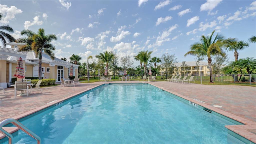 1915 Bridgepointe Circle, Unit 41 Vero Beach, FL 32967 - Photo 31 of 36 a view of a swimming pool and a yard