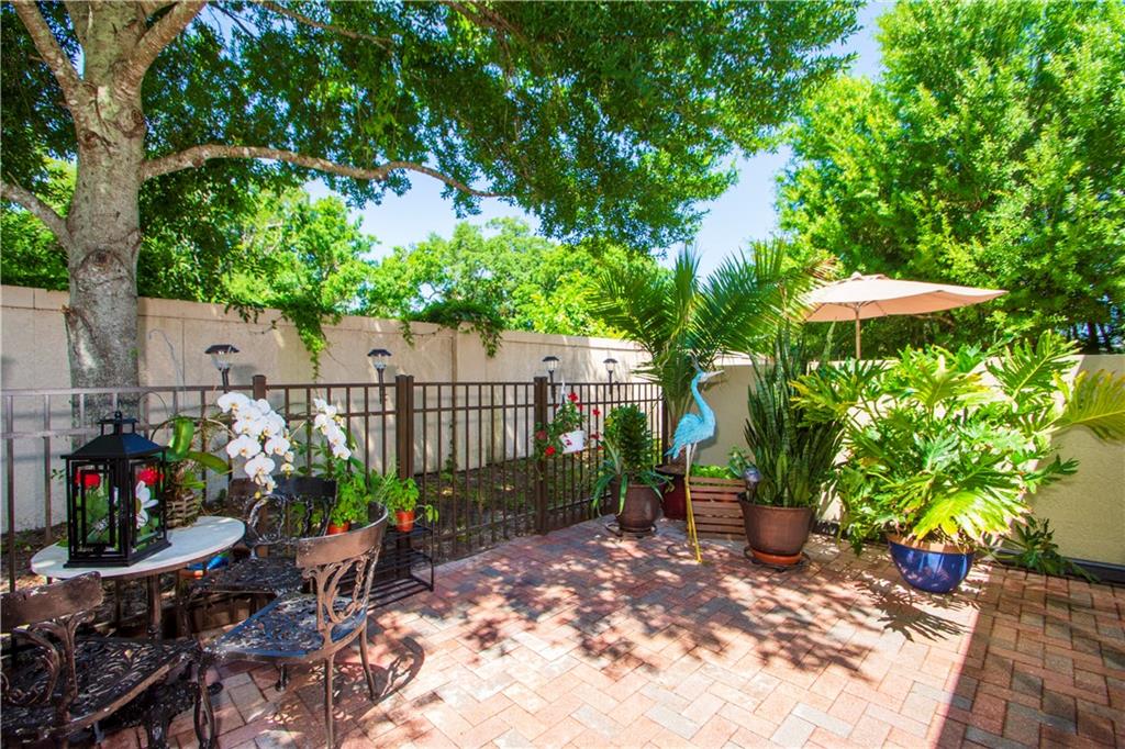 1915 Bridgepointe Circle, Unit 41 Vero Beach, FL 32967 - Photo 4 of 36 a view of a backyard with plants and a patio
