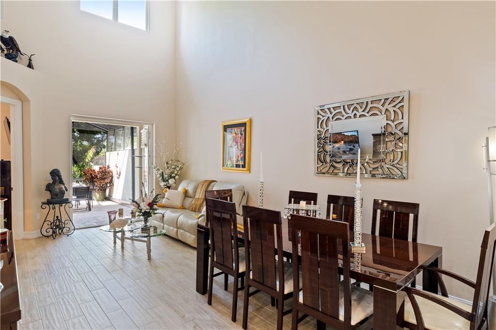 1915 Bridgepointe Circle, Unit 41 Vero Beach, FL 32967 - Photo 6 of 36 a view of a dining room with furniture and wooden floor