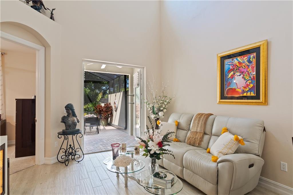 1915 Bridgepointe Circle, Unit 41 Vero Beach, FL 32967 - Photo 8 of 36 a living room with furniture and wooden floor