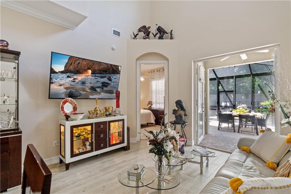 1915 Bridgepointe Circle, Unit 41 Vero Beach, FL 32967 - Photo 9 of 36 a living room with furniture a rug and white walls