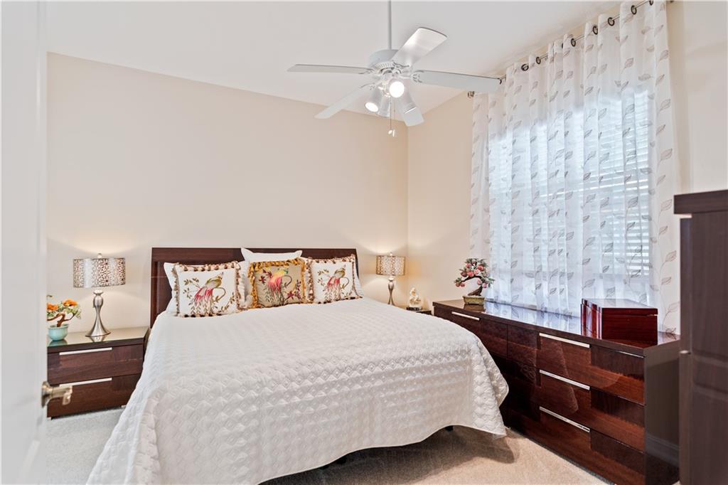 1915 Bridgepointe Circle, Unit 41 Vero Beach, FL 32967 - Photo 10 of 36 a bedroom with a bed and a chandelier