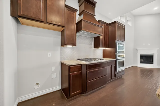 a kitchen with stainless steel appliances granite countertop a stove and a refrigerator