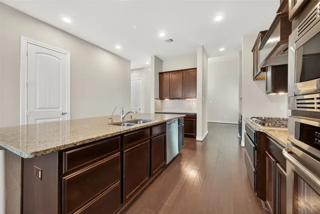 a kitchen with stainless steel appliances granite countertop a stove and a sink