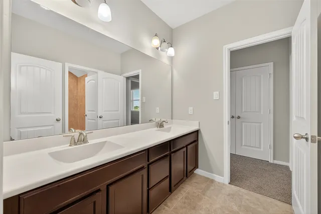 a bathroom with a sink double vanity and a mirror