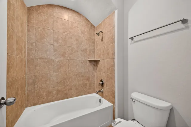a bathroom with a bathtub and a toilet
