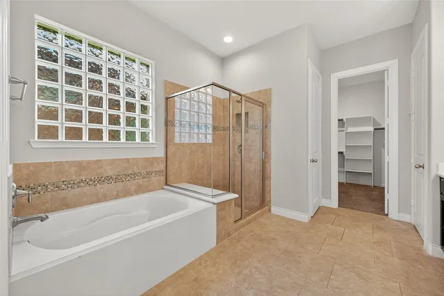 a bathroom with a bathtub and a shower