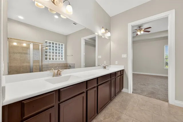 a bathroom with a sink double vanity and a mirror