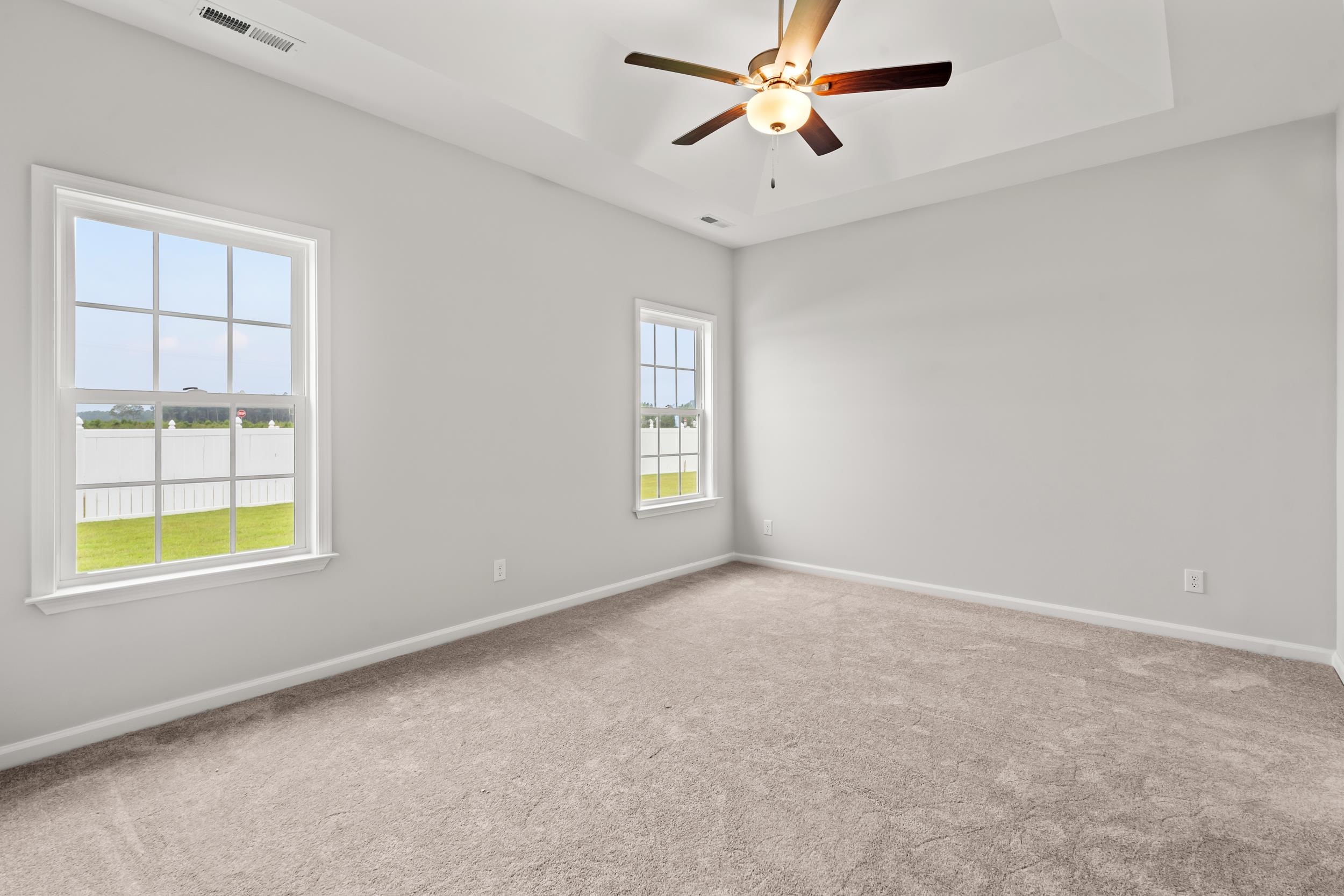 231 Stillbrook Drive Longs, SC 29568 - Photo 16 of 38 Spare room with a raised ceiling, carpet floors, and ceiling fan