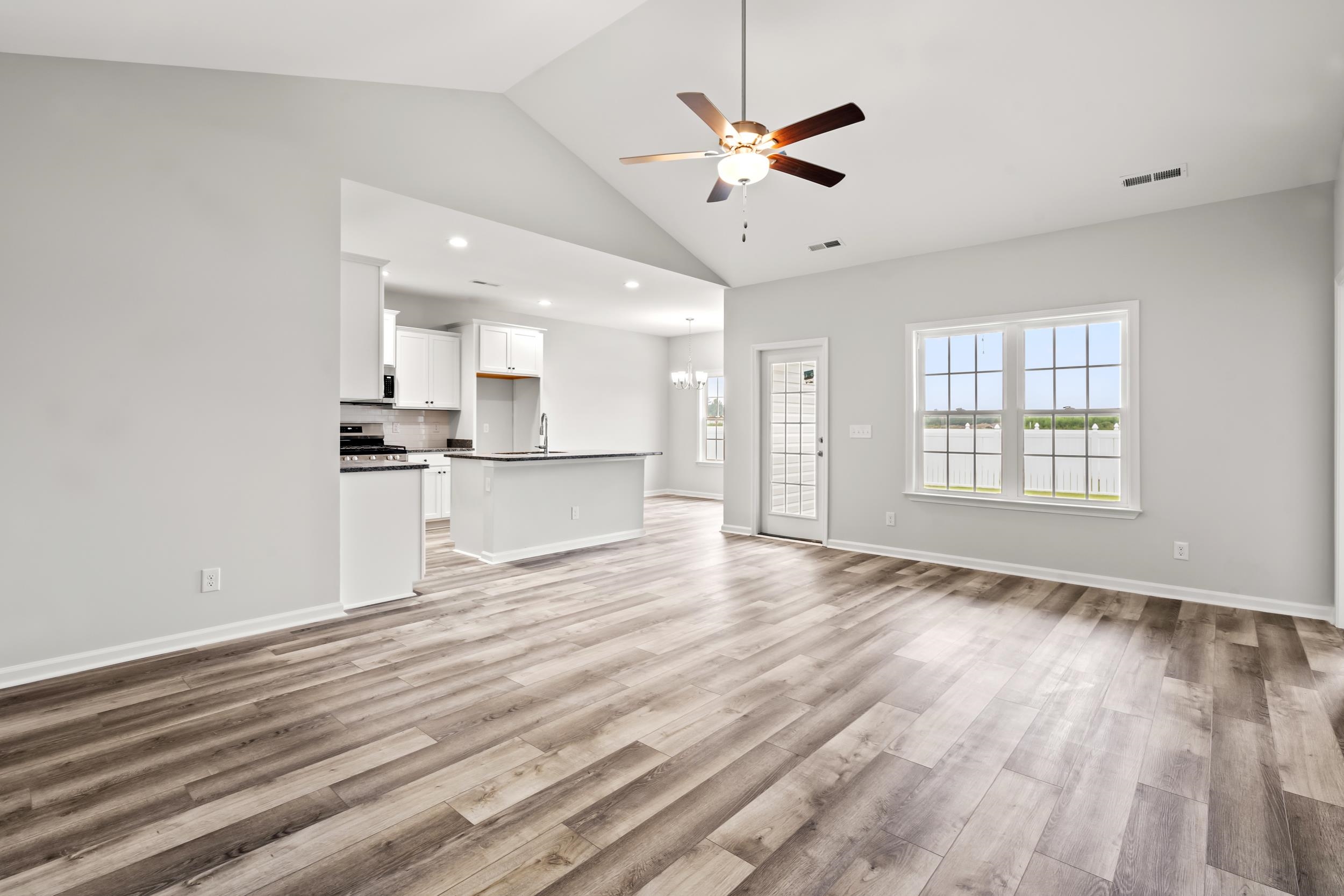 231 Stillbrook Drive Longs, SC 29568 - Photo 2 of 38 Unfurnished living room featuring a ceiling fan, light wood finished floors, a chandelier, and high vaulted ceiling