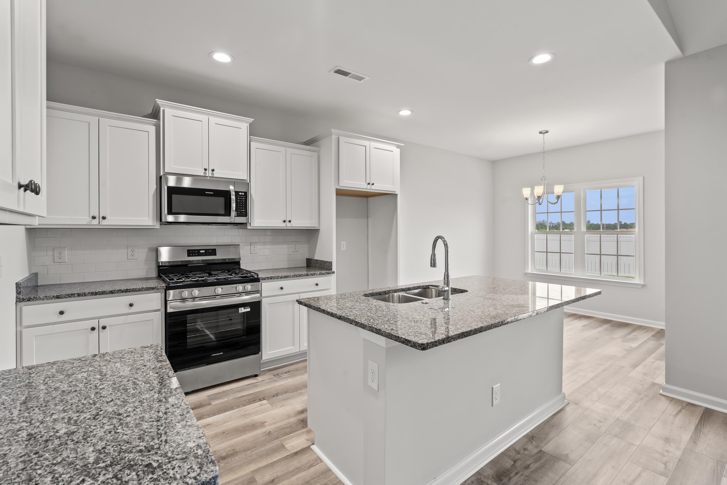 231 Stillbrook Drive Longs, SC 29568 - Photo 4 of 38 Kitchen with stainless steel appliances, dark stone countertops, decorative backsplash, white cabinetry, and recessed lighting