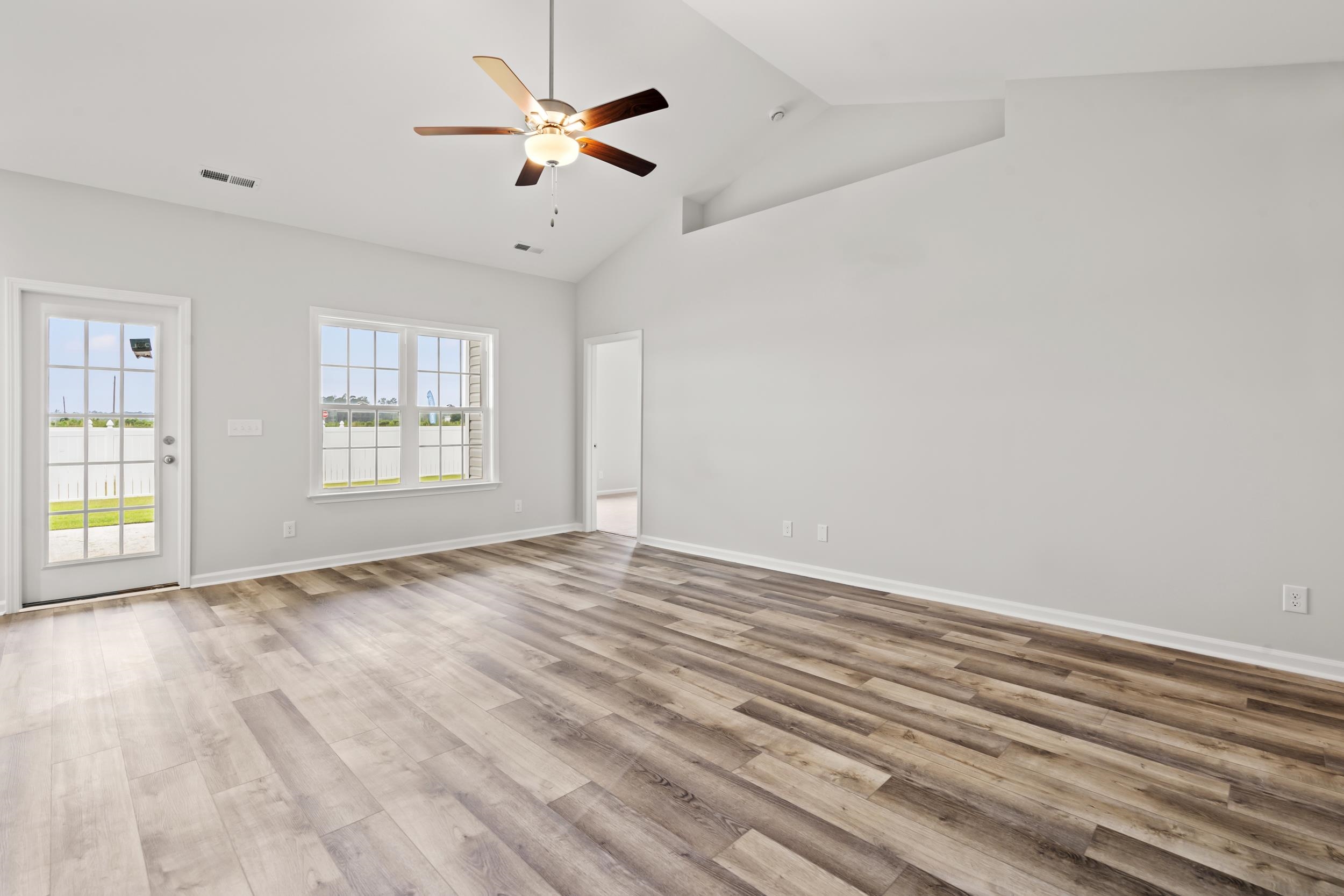 231 Stillbrook Drive Longs, SC 29568 - Photo 6 of 38 Unfurnished room with a ceiling fan, high vaulted ceiling, and light wood-type flooring