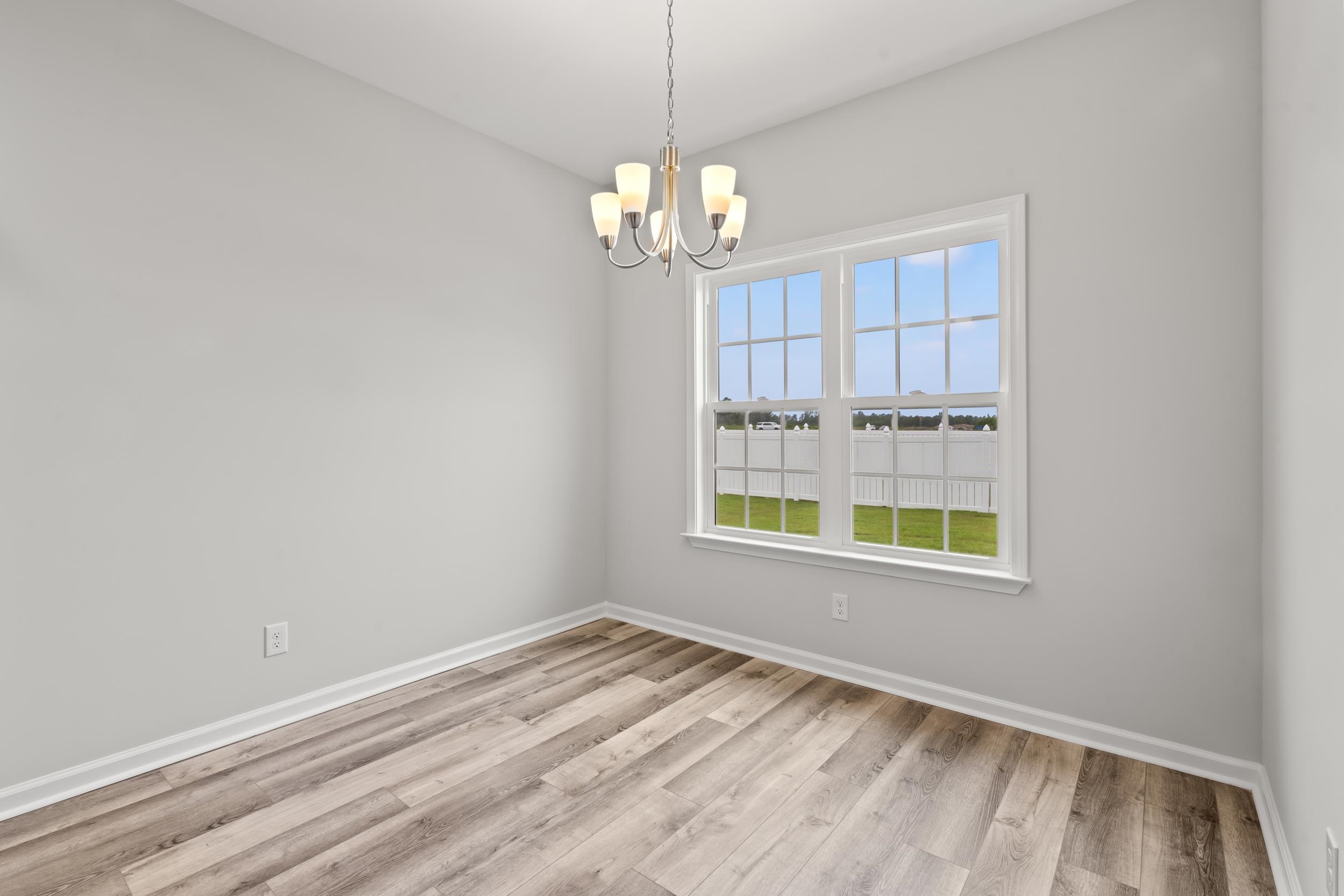 231 Stillbrook Drive Longs, SC 29568 - Photo 7 of 38 Spare room featuring light wood-type flooring and a chandelier