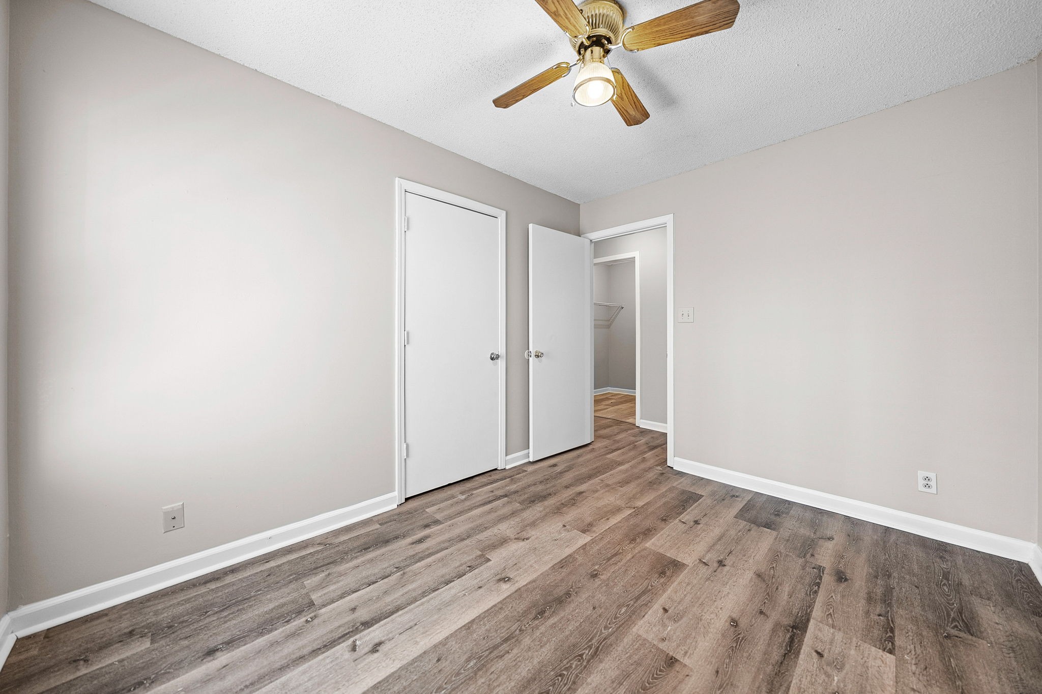 1539 Hugh Hunter Road Oak Grove, KY 42262 - Photo 15 of 22 an empty room with wooden floor fan and windows