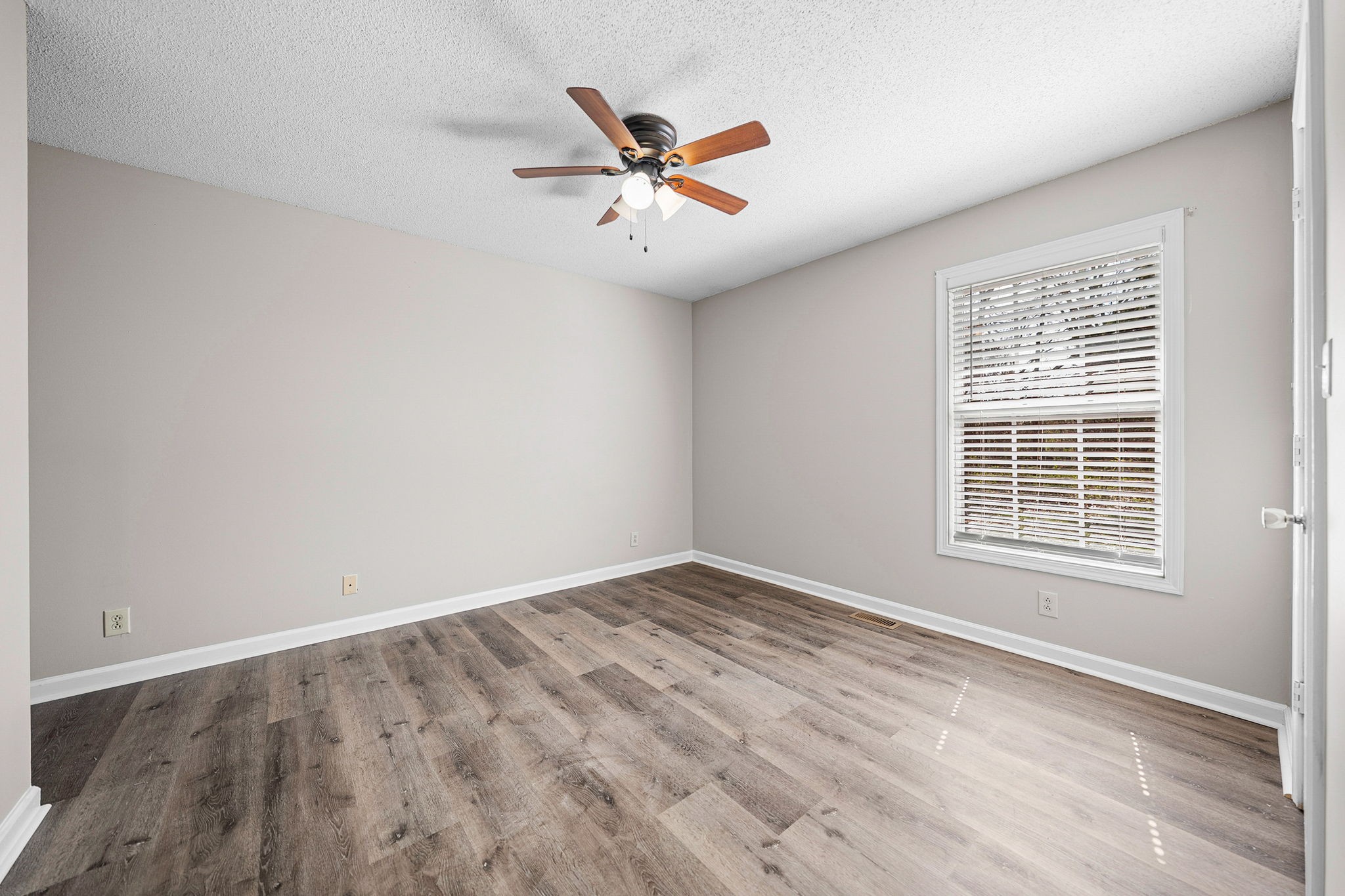 1539 Hugh Hunter Road Oak Grove, KY 42262 - Photo 18 of 22 a view of a livingroom with a ceiling fan and wooden floor