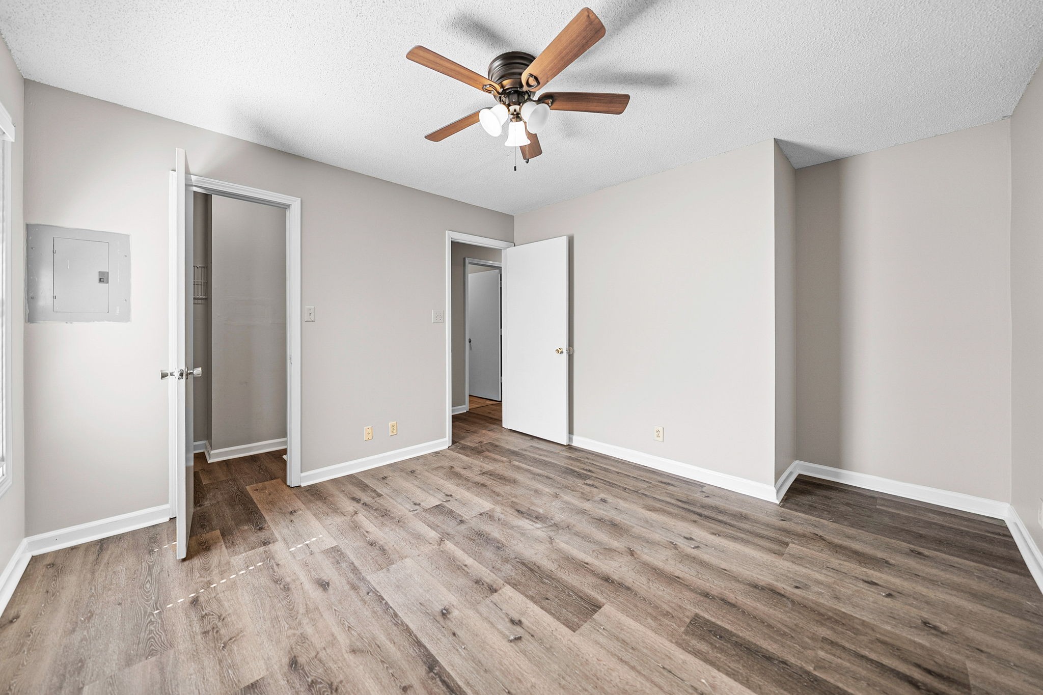 1539 Hugh Hunter Road Oak Grove, KY 42262 - Photo 19 of 22 an empty room with wooden floor and ceiling fan