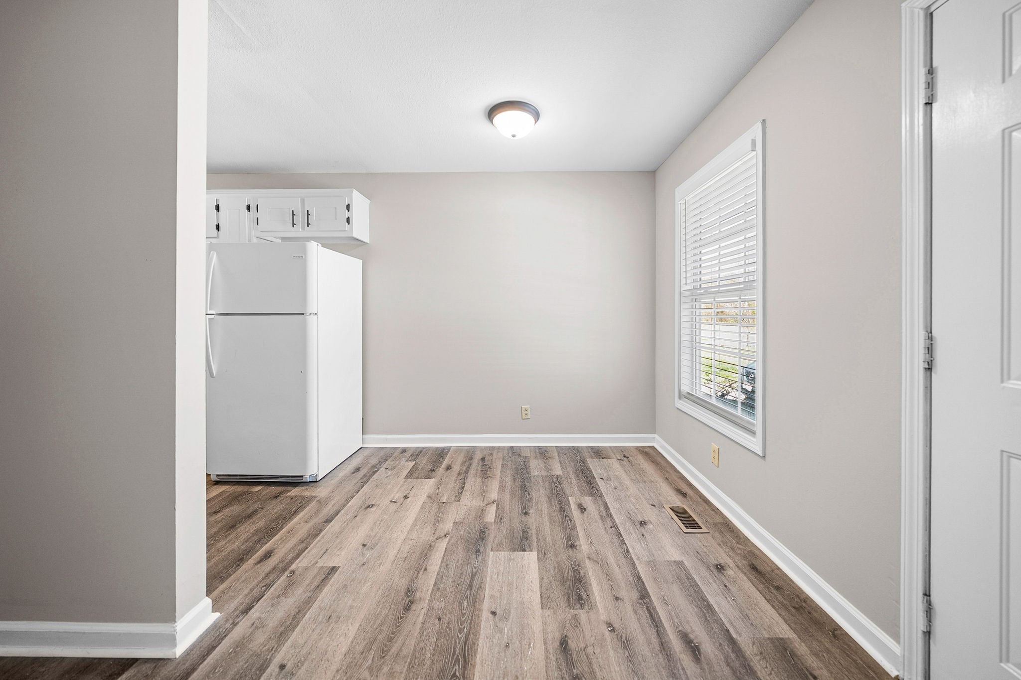 1539 Hugh Hunter Road Oak Grove, KY 42262 - Photo 8 of 22 an empty room with wooden floor and windows