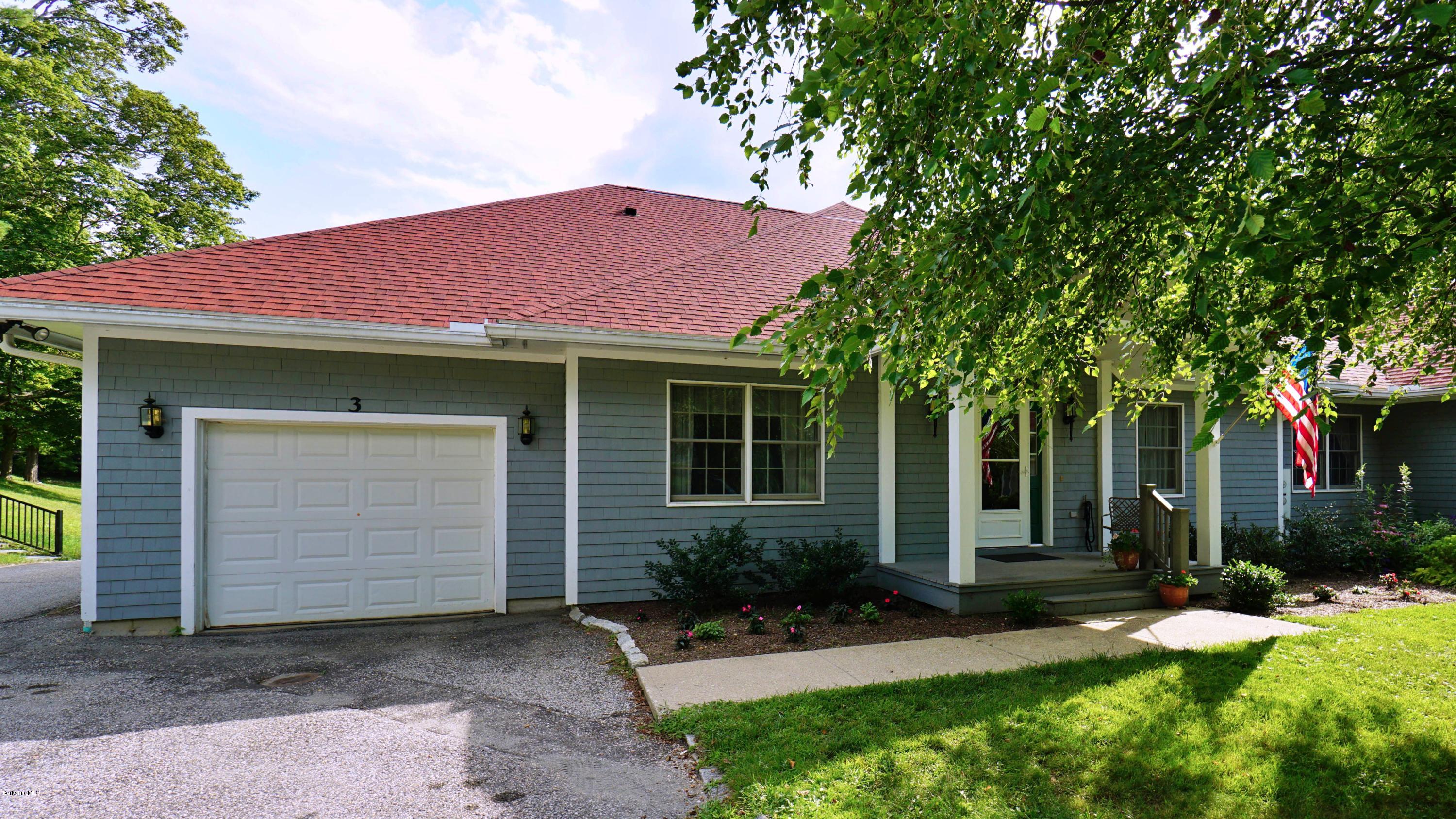 11 Prospect Hill Road, Unit 3 Stockbridge, MA 01262 - Photo 2 of 27 a front view of a house with a yard and garage