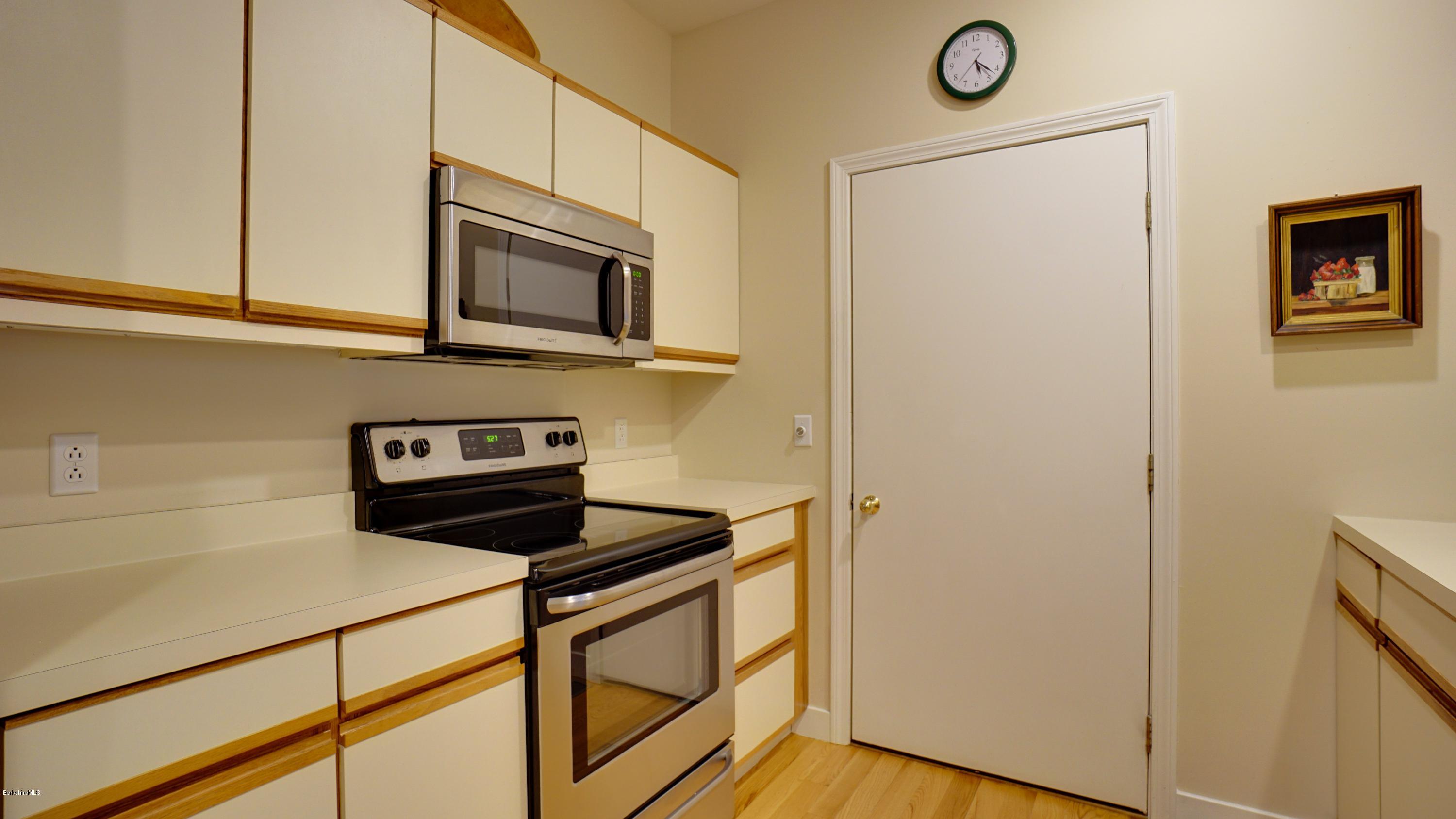 11 Prospect Hill Road, Unit 3 Stockbridge, MA 01262 - Photo 8 of 27 a kitchen with stainless steel appliances a stove a microwave and a refrigerator