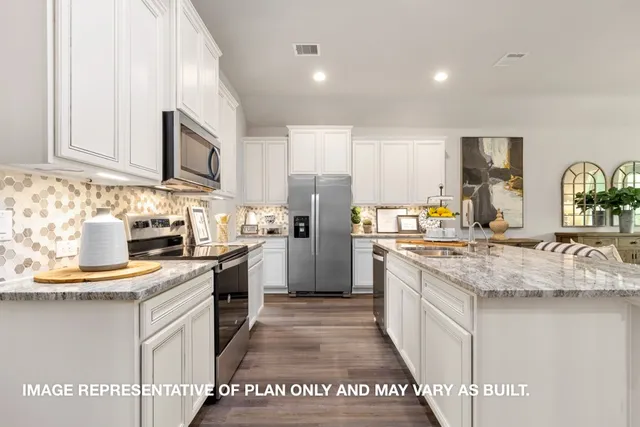 a kitchen with stainless steel appliances granite countertop a stove top oven a sink and white cabinets