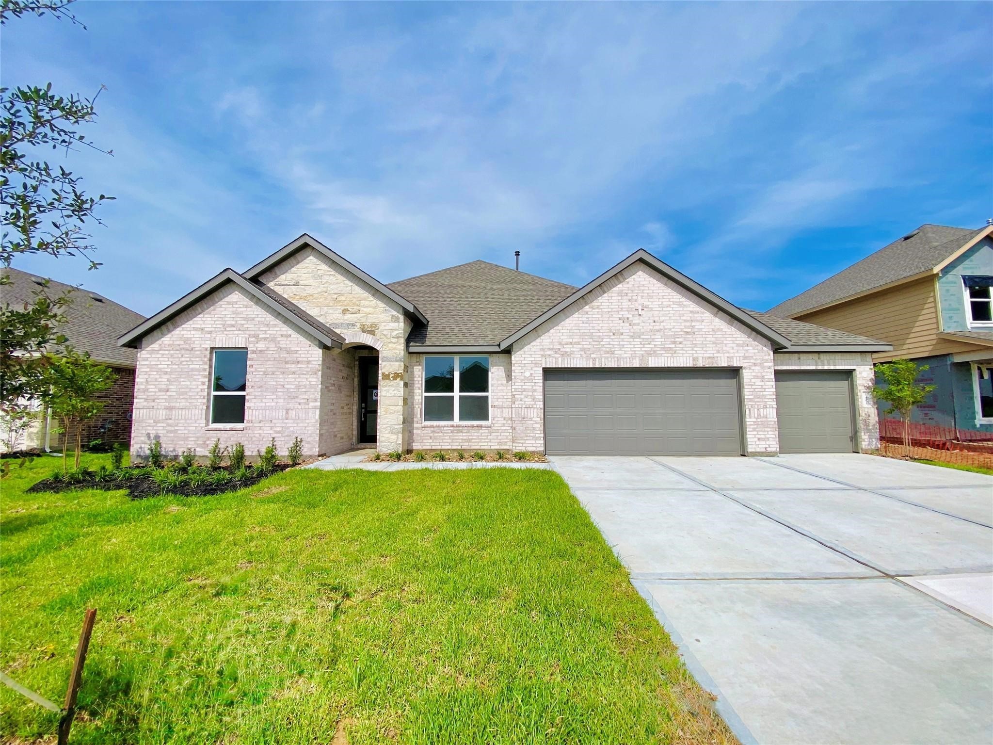 1421 Imperial Ranch Way Dayton, TX 77535 - Photo 11 of 19 a view of a house with a yard and garage