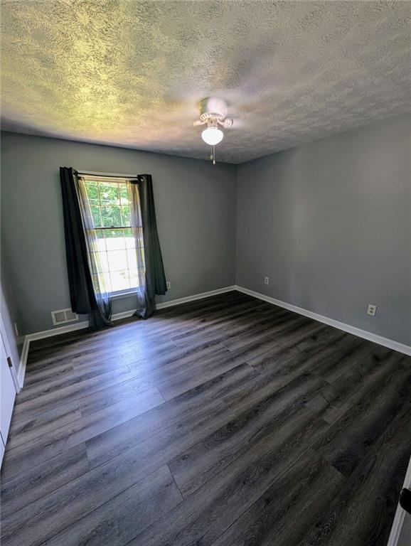 1848 Christian Circle Southeast Conyers, GA 30013 - Photo 5 of 11 an empty room with wooden floor and windows