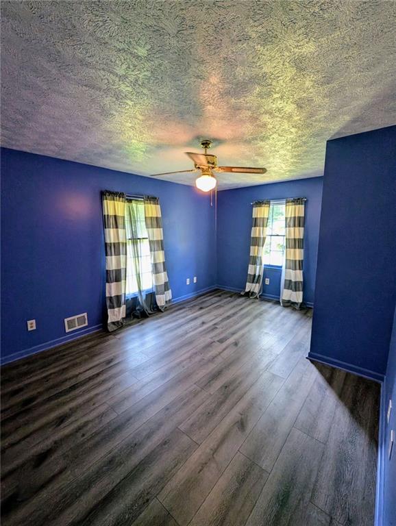 1848 Christian Circle Southeast Conyers, GA 30013 - Photo 6 of 11 an empty room with wooden floor and windows