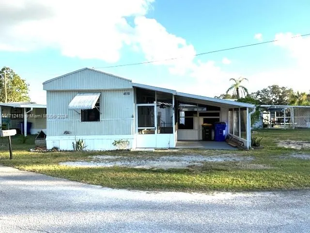 a view of a house with a swimming pool and a yard