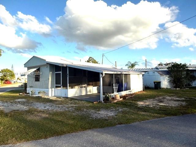 4510 Welcome Drive Sebring, FL 33870 - Photo 2 of 28 a view of a house with a yard and a large tree