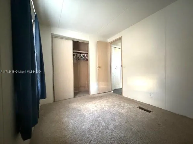 an empty room with closet area