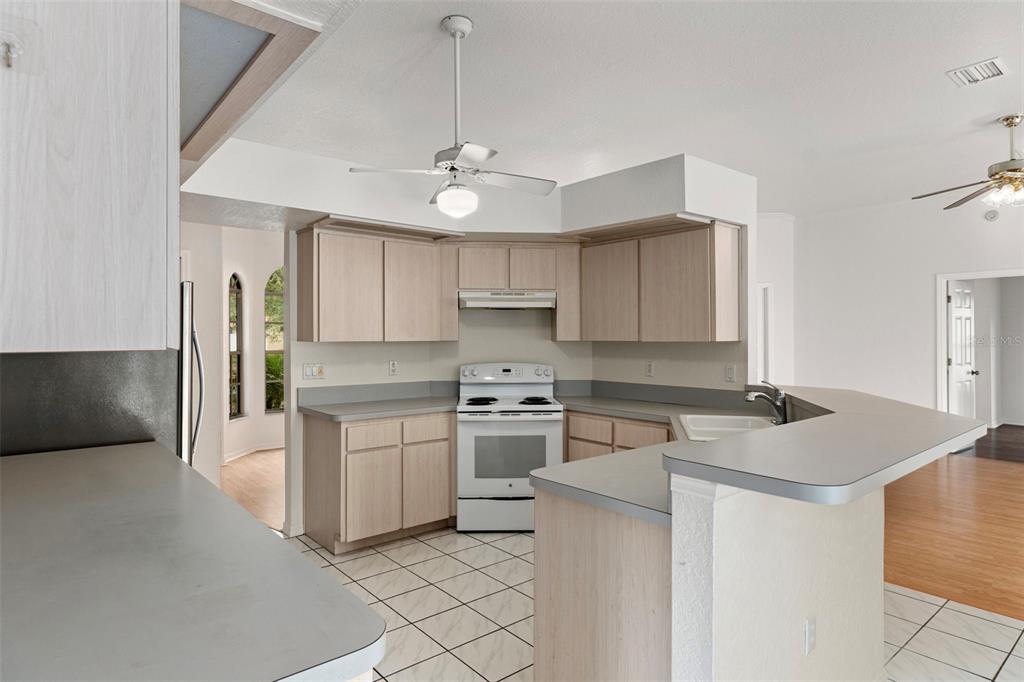 2214 Meadow Lark Road Spring Hill, FL 34608 - Photo 15 of 49 a kitchen with stainless steel appliances granite countertop a sink and a stove