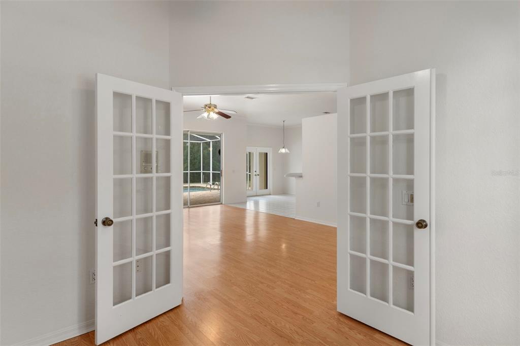 2214 Meadow Lark Road Spring Hill, FL 34608 - Photo 20 of 49 a view of an empty room with wooden floor and a window