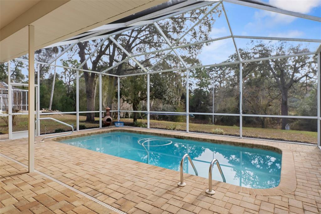 2214 Meadow Lark Road Spring Hill, FL 34608 - Photo 2 of 49 a view of a swimming pool with a porch