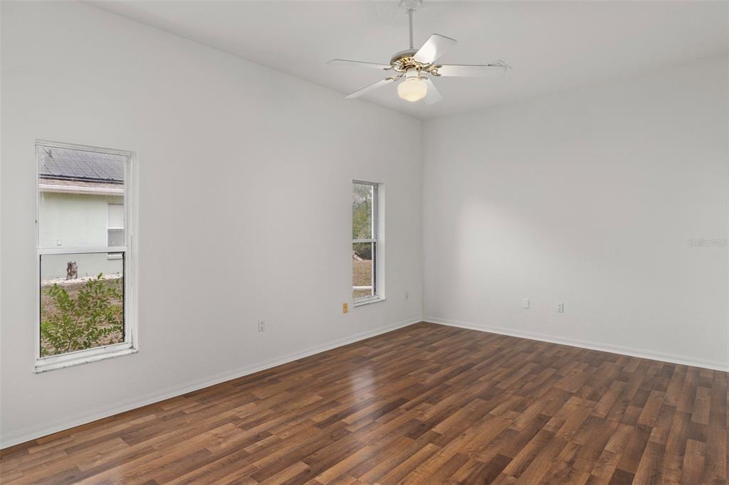 2214 Meadow Lark Road Spring Hill, FL 34608 - Photo 21 of 49 wooden floor in an empty room with a window