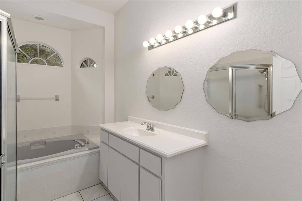 2214 Meadow Lark Road Spring Hill, FL 34608 - Photo 25 of 49 a bathroom with a sink mirror and vanity
