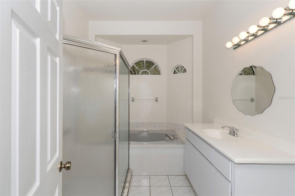 2214 Meadow Lark Road Spring Hill, FL 34608 - Photo 26 of 49 a bathroom with a sink a toilet and shower