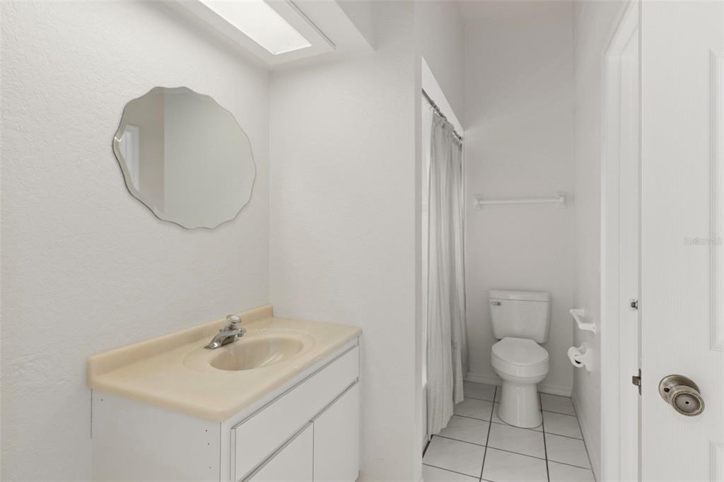 2214 Meadow Lark Road Spring Hill, FL 34608 - Photo 28 of 49 a bathroom with a toilet a sink and mirror