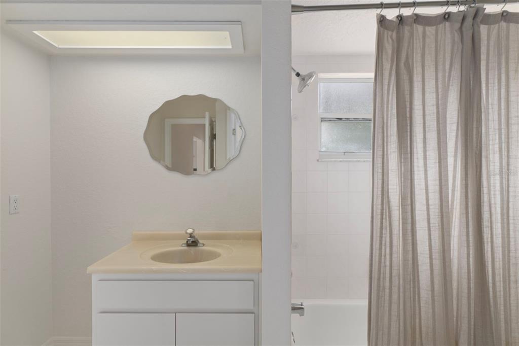 2214 Meadow Lark Road Spring Hill, FL 34608 - Photo 29 of 49 a bathroom with a sink and a mirror