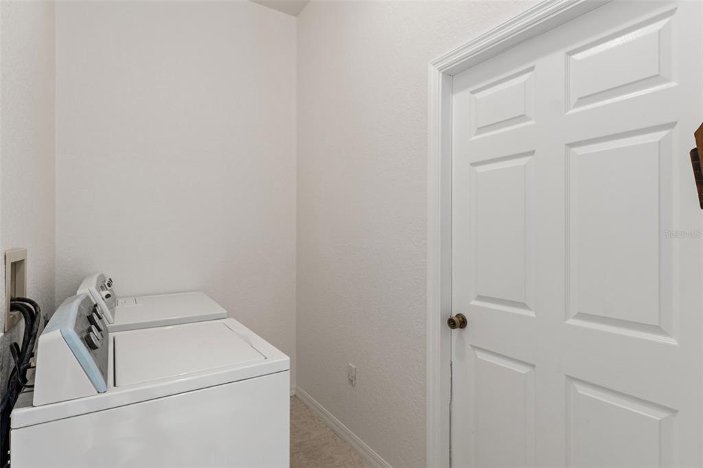 2214 Meadow Lark Road Spring Hill, FL 34608 - Photo 35 of 49 a utility room with dryer and washer